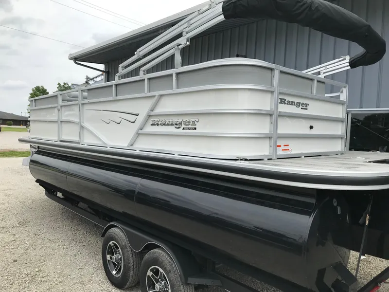 Slide: The Image of 2024 Ranger Reata 223C pontoon boat on a trailer, side view. - 2