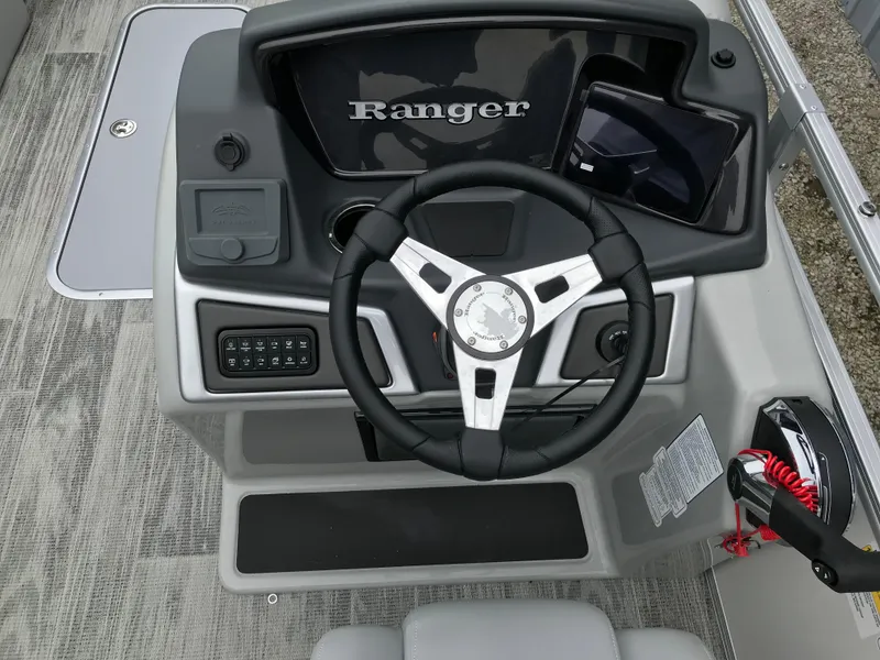 Slide: The Image of 2024 Ranger Reata 223C boat dashboard with steering wheel and control panel. - 5
