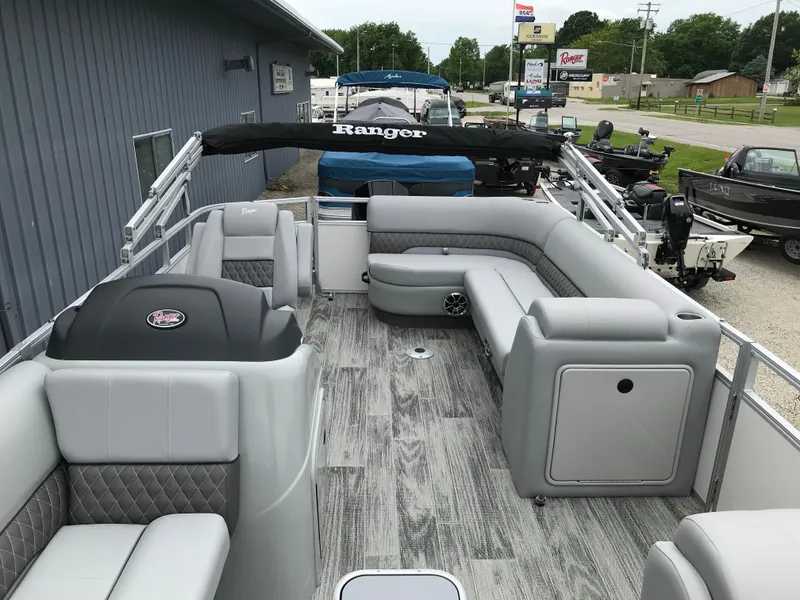 Slide: The Image of 2024 Ranger Reata 223C pontoon boat with spacious seating and modern interior design. - 6