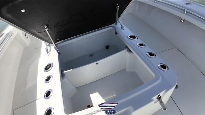 Slide: The Image of 2020 Costa Custom Boats 264 HC interior with open storage compartment and rod holders. - 12