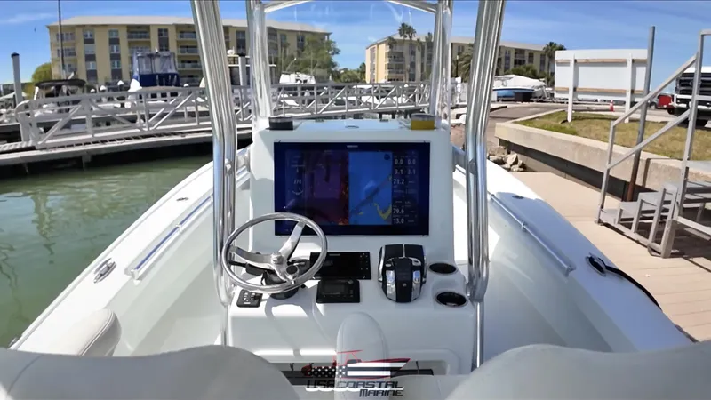Slide: The Image of 2020 Costa Custom Boats 264 HC dashboard with navigation screen at marina. - 14