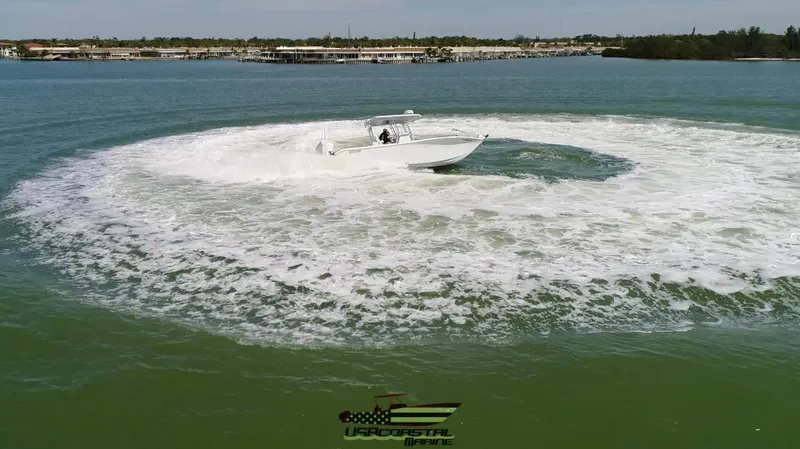 Slide: The Image of 2020 Costa Custom Boats 264 HC performing a high-speed turn on open water. - 15