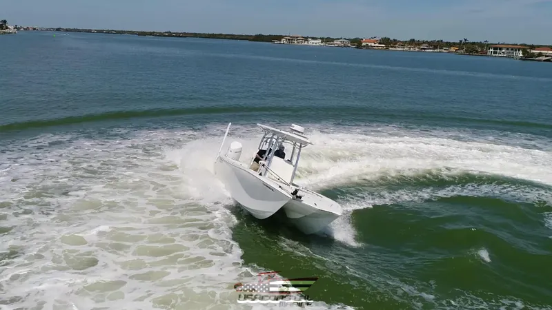 Slide: The Image of 2020 Costa Custom Boats 264 HC making a sharp turn on open water. - 20