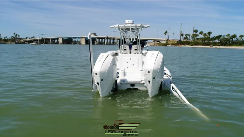 Slide: The Image of 2020 Costa Custom Boats 264 HC on water, rear view, near a bridge. - 21