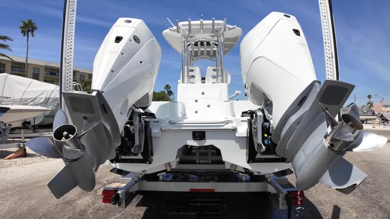 Slide: The Image of 2020 Costa Custom Boats 264 HC with dual outboard engines on a trailer. - 24