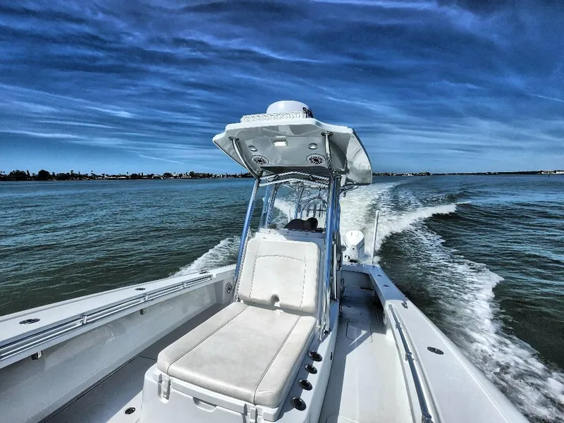 Slide: The Image of 2020 Costa Custom Boats 264 HC cruising on open water under a clear blue sky. - 25