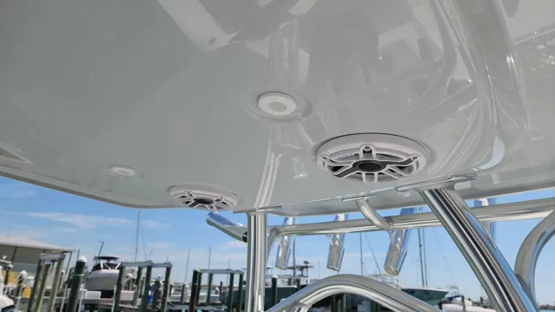 Slide: The Image of 2020 Costa Custom Boats 264 HC, featuring sleek overhead speakers and polished metal framework. - 34