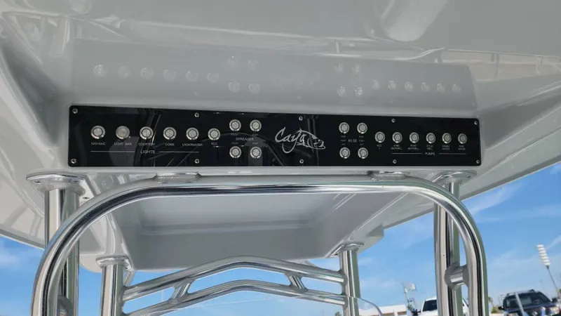 Slide: The Image of Control panel of 2020 Costa Custom Boats 264 HC with clear blue sky background. - 35