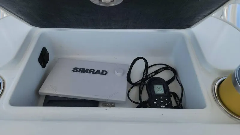 Slide: The Image of Storage compartment in 2020 Costa Custom Boats 264 HC with Simrad equipment and cables. - 36