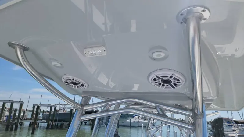 Slide: The Image of T-top of 2020 Costa Custom Boats 264 HC with speakers and lights, docked at marina. - 39