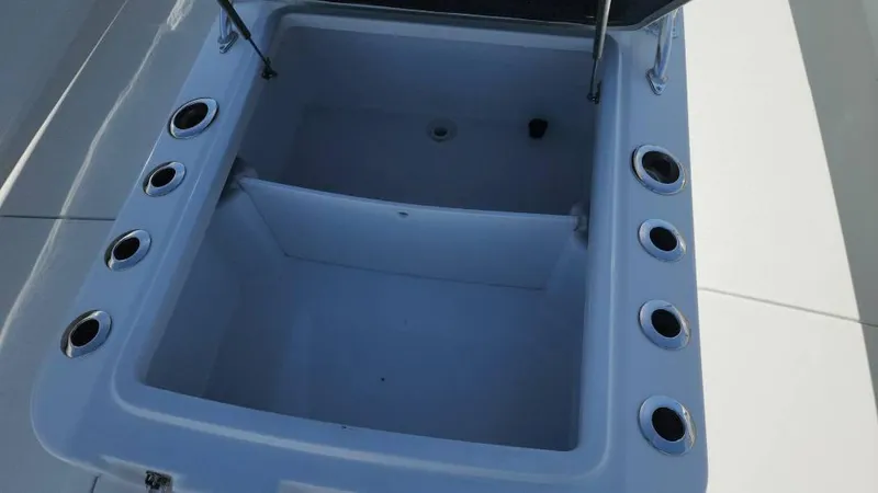 Slide: The Image of Open storage compartment on 2020 Costa Custom Boats 264 HC, featuring multiple cup holders. - 41