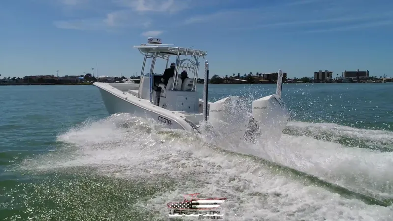 Slide: The Image of 2020 Costa Custom Boats 264 HC cruising on open water, creating a dynamic wake. - 5