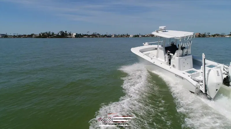 Slide: The Image of 2020 Costa Custom Boats 264 HC cruising on open water, scenic coastal background. - 6