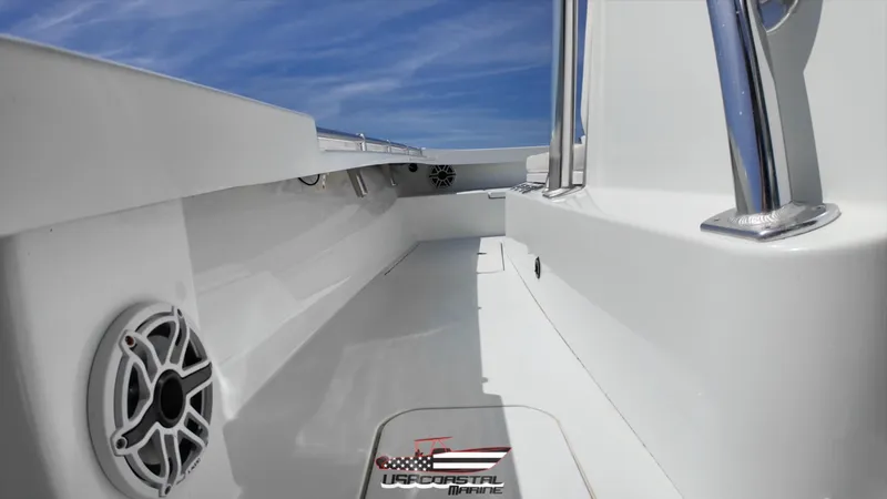 Slide: The Image of 2020 Costa Custom Boats 264 HC interior with sleek white design and marine speakers. - 8