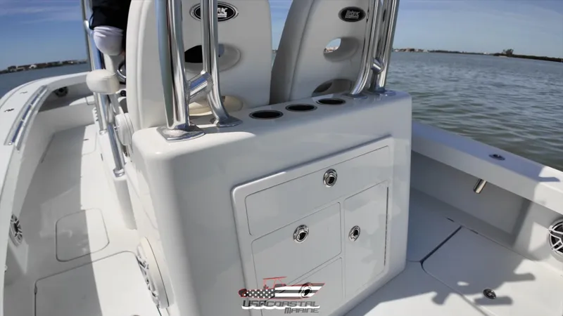 Slide: The Image of 2020 Costa Custom Boats 264 HC interior with storage and seating on calm water. - 9