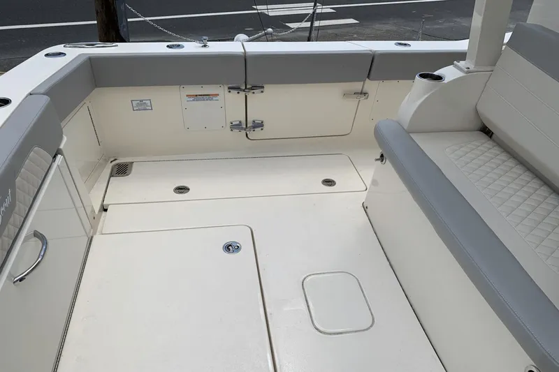 Slide: The Image of 2024 Scout 357LXF boat interior with cushioned seating and storage compartments. - 6
