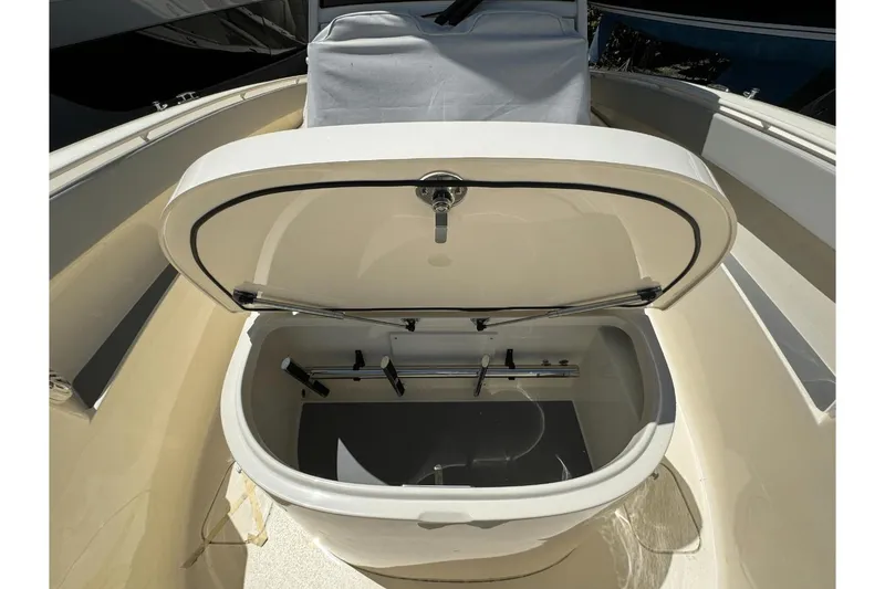 Slide: The Image of Open storage compartment on 2024 Scout 357LXF boat, showcasing interior features. - 29