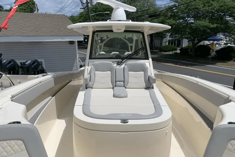 Slide: The Image of 2024 Scout 357LXF boat interior with cushioned seating and modern design. - 16