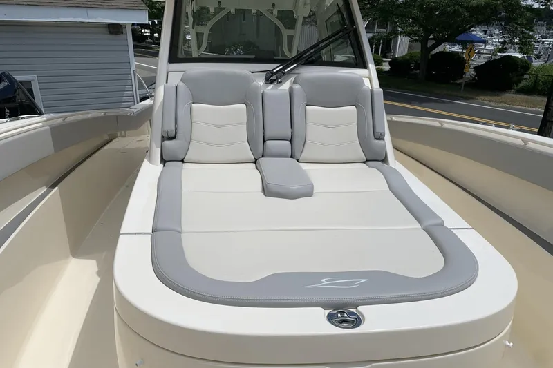 Slide: The Image of 2024 Scout 357LXF boat with luxurious gray and white seating on deck. - 17