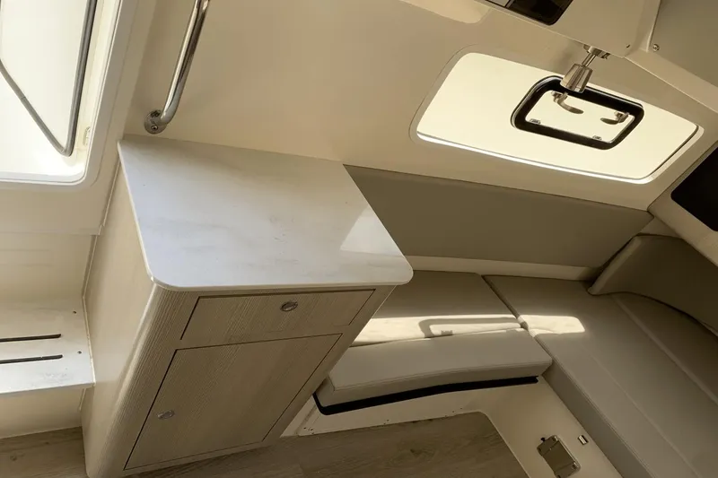 Slide: The Image of 2024 Scout 357LXF interior with sleek cabinetry and seating, featuring modern design elements. - 26