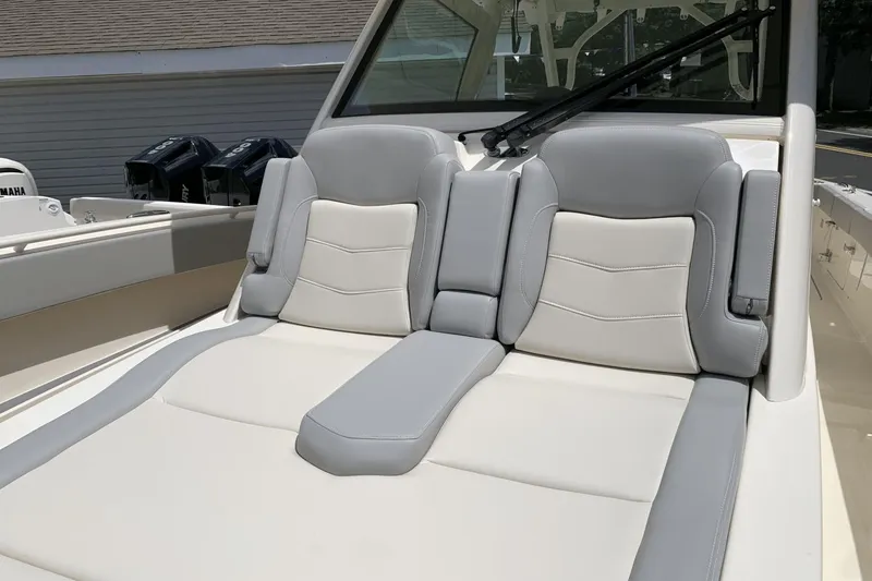 Slide: The Image of 2024 Scout 357LXF boat with luxurious gray and white seating. - 18