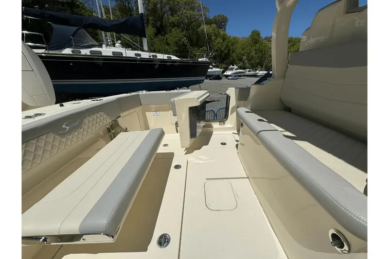 Slide: The Image of 2024 Scout 357LXF boat interior with beige seating and sleek design. - 12