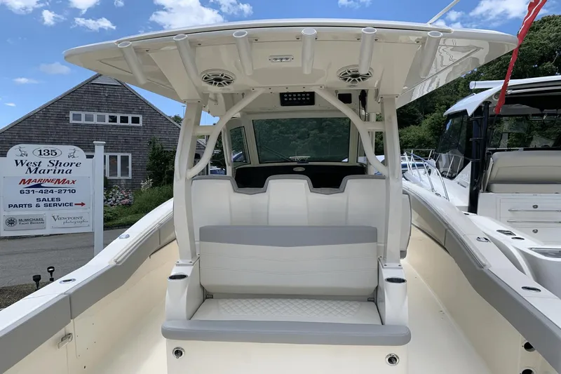 Slide: The Image of 2024 Scout 357LXF boat at West Shore Marina, showcasing seating and helm area. - 8
