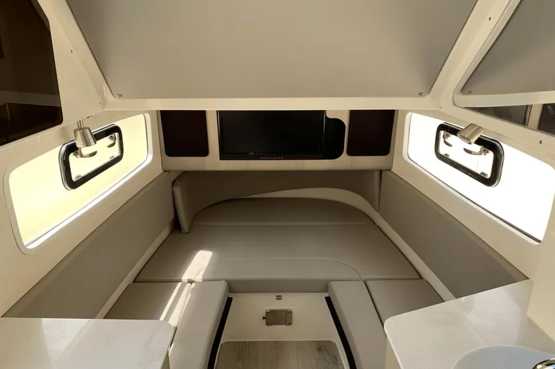 Slide: The Image of 2024 Scout 357LXF cabin interior with seating, windows, and a mounted TV. - 28