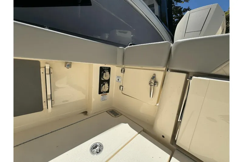 Slide: The Image of 2024 Scout 357LXF boat interior with storage compartments and control panel. - 7