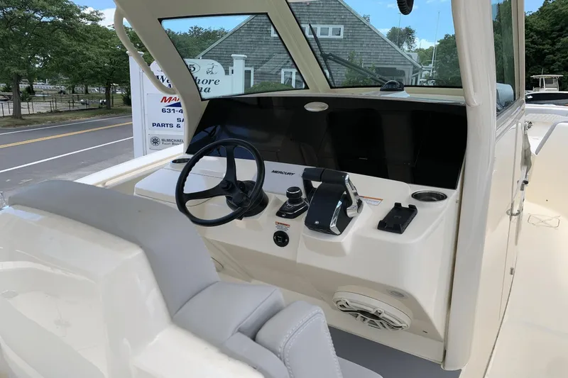 Slide: The Image of 2024 Scout 357LXF boat dashboard with steering wheel and controls. - 14