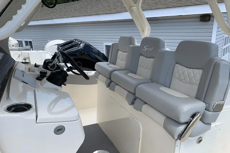 Slide: The Image of 2024 Scout 357LXF boat interior with luxurious gray seating and modern helm controls. - 13