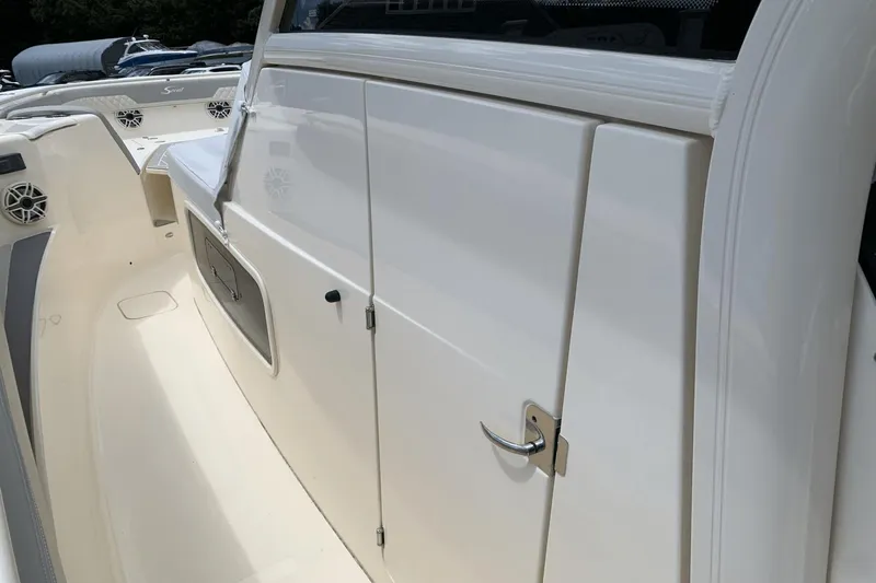 Slide: The Image of 2024 Scout 357LXF boat interior with sleek white cabinetry and modern design. - 21