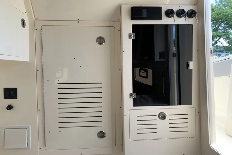 Slide: The Image of 2024 Scout 357LXF boat interior with control panel and storage compartments. - 22