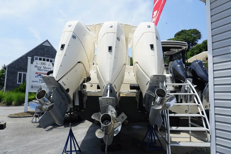 Slide: The Image of 2024 Scout 357LXF boat with triple outboard engines at West Shore Marina. - 3