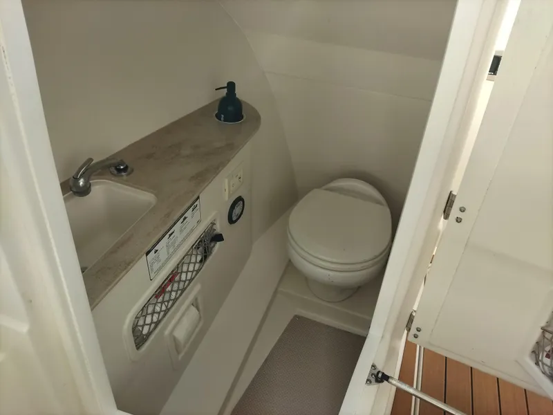 Slide: The Image of 2020 Sailfish 275 DC boat bathroom with sink and toilet. - 12