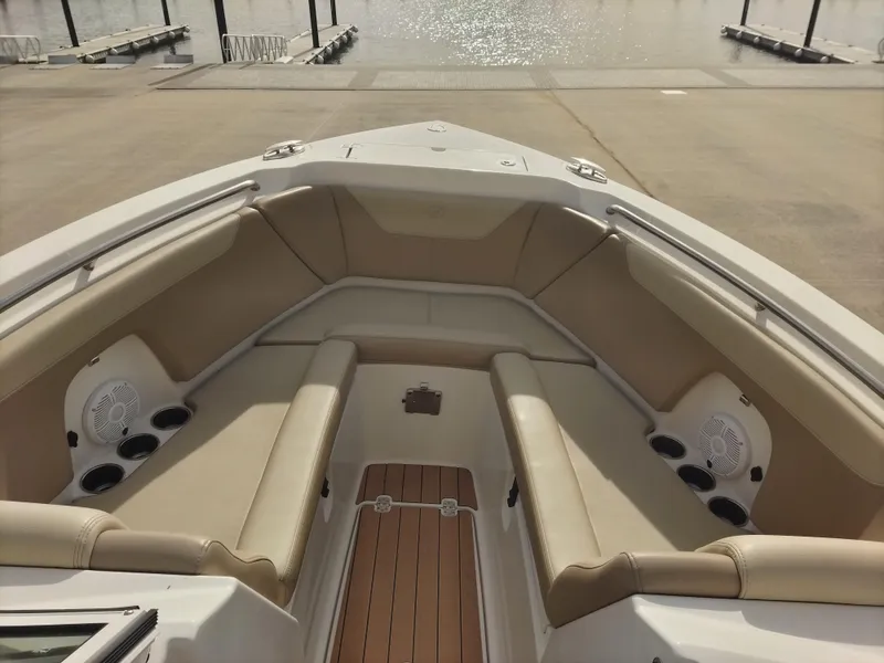 Slide: The Image of 2020 Sailfish 275 DC boat interior with beige seating and cup holders. - 14