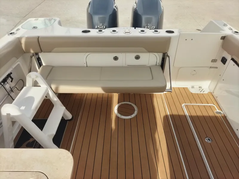 Slide: The Image of 2020 Sailfish 275 DC boat interior with teak flooring and seating. - 7