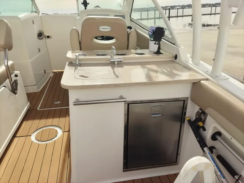 Slide: The Image of 2020 Sailfish 275 DC boat interior with sink and storage. - 9