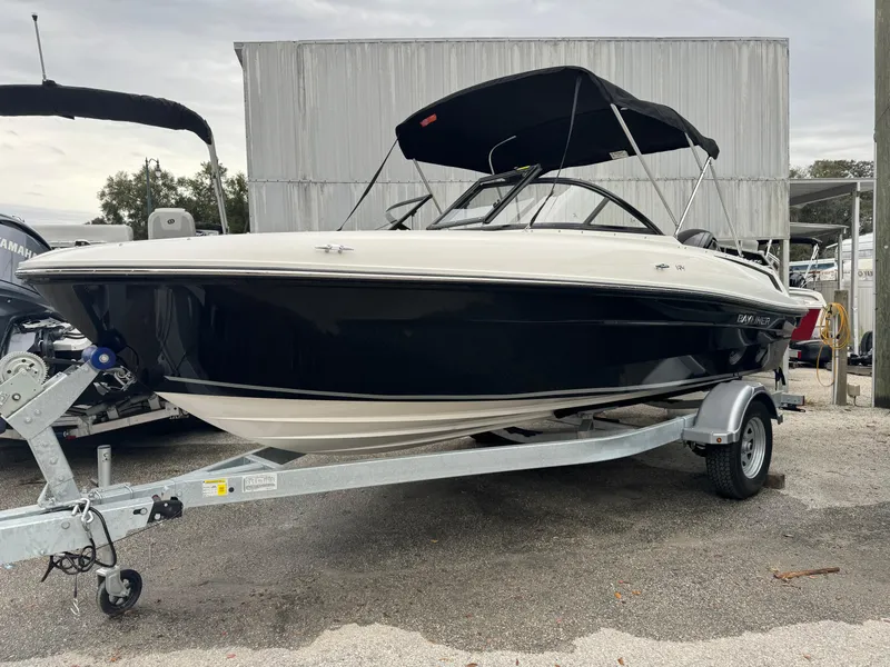 The Image of 2026 Bayliner VR4 Bowrider OB on trailer, black and white design. - 0