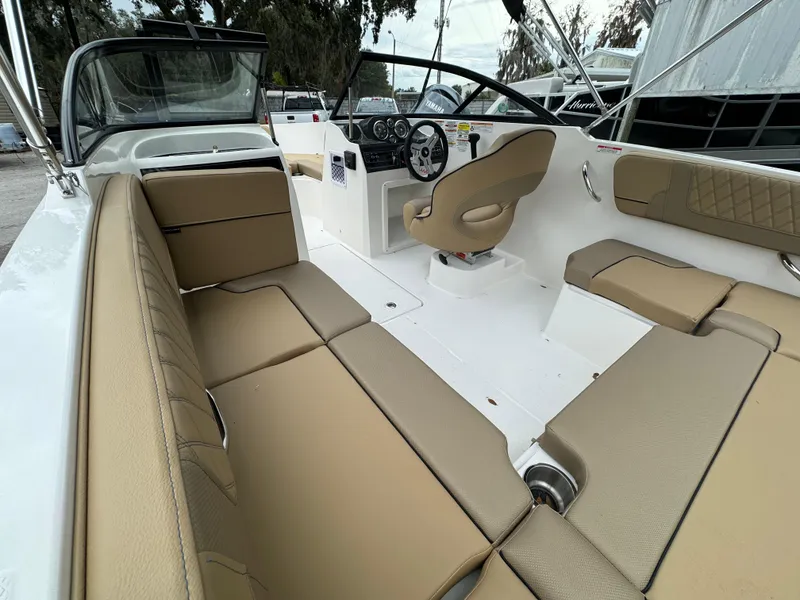 Slide: The Image of Interior of 2026 Bayliner VR4 Bowrider OB with beige seating. - 2
