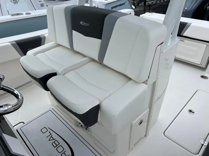 Slide: The Image of 2024 Robalo R270 boat seating with white and black upholstery. - 11