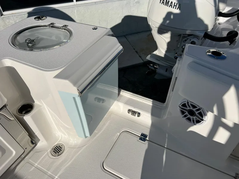Slide: The Image of 2024 Robalo R270 boat interior with Yamaha engine and storage compartments. - 15