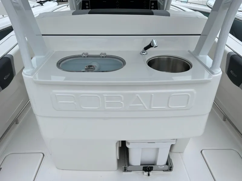 Slide: The Image of 2024 Robalo R270 boat interior with sink and storage area. - 6