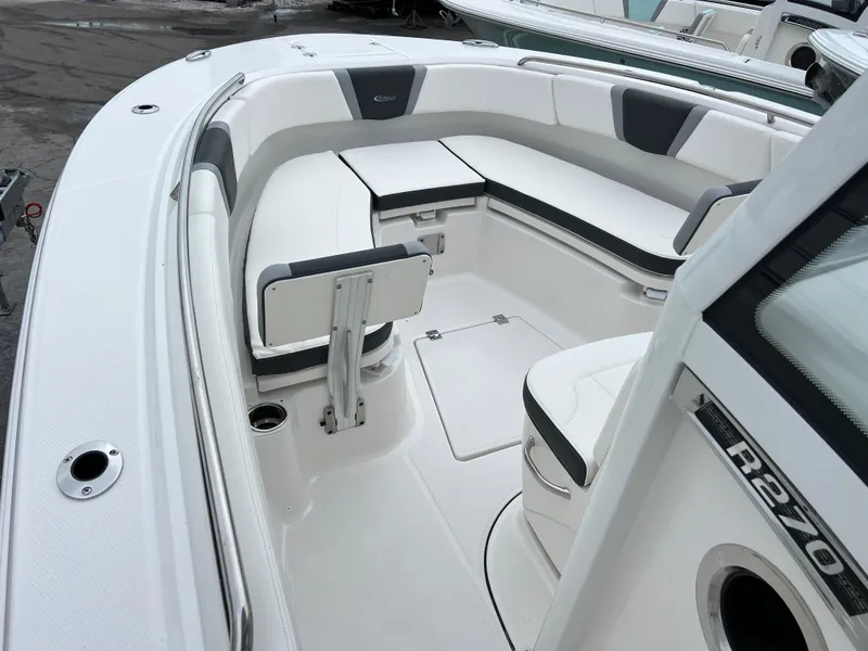 Slide: The Image of 2024 Robalo R270 boat interior with sleek seating and modern design. - 9