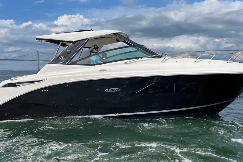 The Image of 2019 Sea Ray Sundancer 320 cruising on the water under a cloudy sky. - 0
