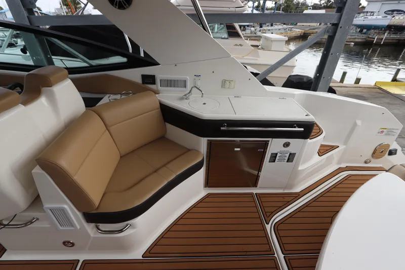 Slide: The Image of 2019 Sea Ray Sundancer 320 yacht interior with tan seating and wood accents. - 11