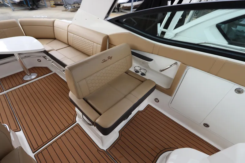 Slide: The Image of 2019 Sea Ray Sundancer 320 interior with tan seating and wood-style flooring. - 15