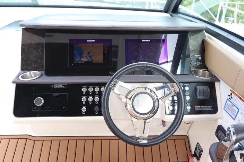 Slide: The Image of 2019 Sea Ray Sundancer 320 helm with dual displays and modern controls. - 18
