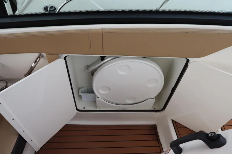 Slide: The Image of 2019 Sea Ray Sundancer 320 boat storage compartment with open hatch and teak flooring. - 24