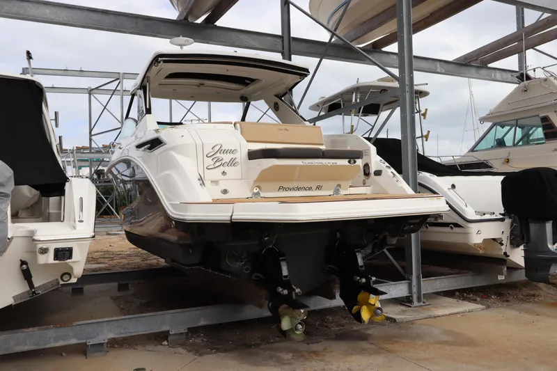 Slide: The Image of 2019 Sea Ray Sundancer 320 yacht in dry dock, rear view, showcasing sleek design. - 3